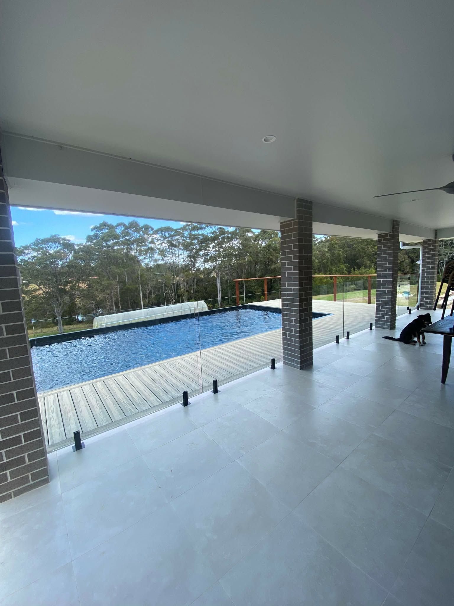 Covered Patio Overlooking an Infinity Pool and Landscaped Garden — Nambucca Glass in Nambucca Heads, NSW