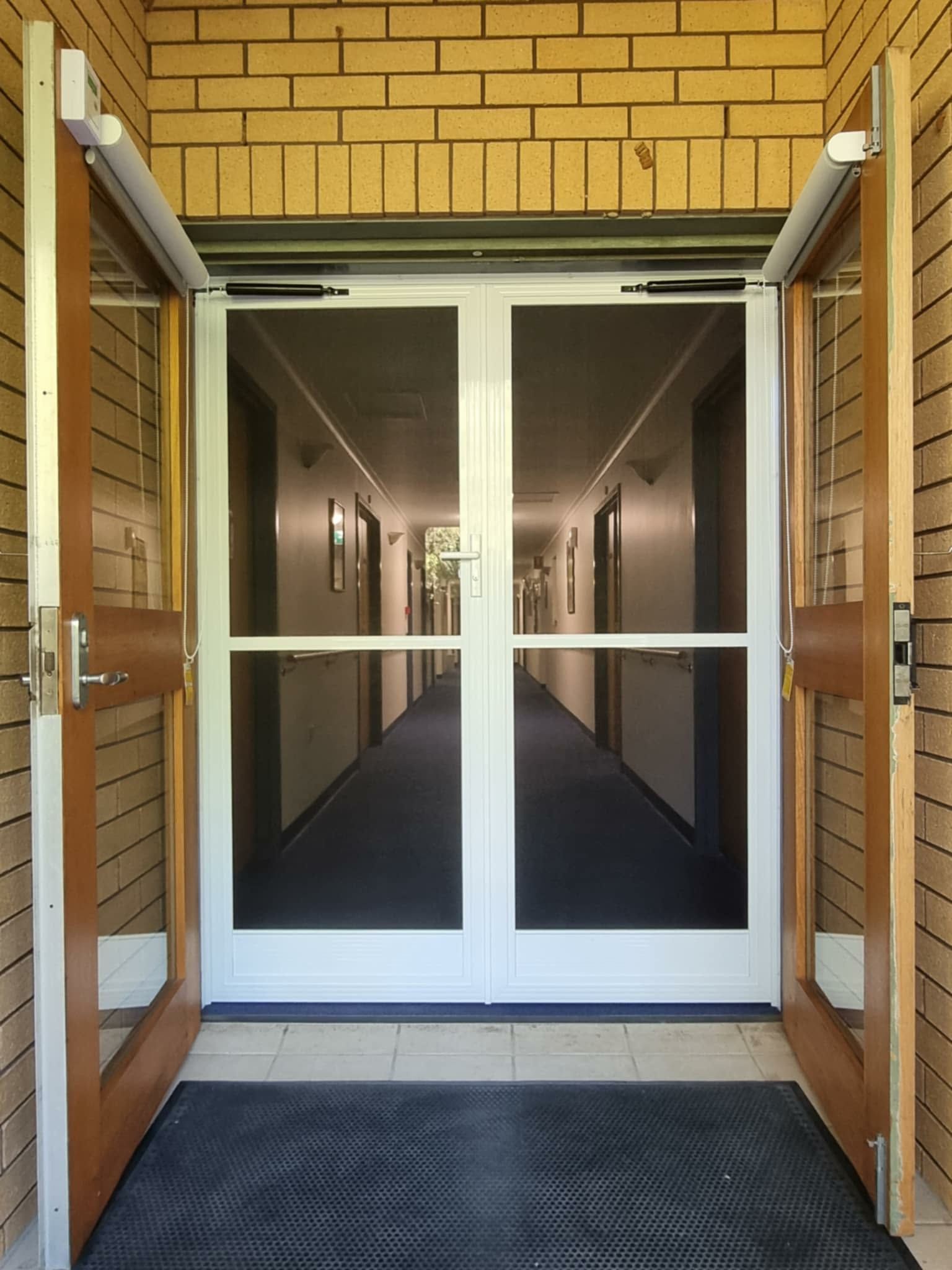 Open Double Glass Doors at a Brick Building Entrance — Nambucca Glass in Nambucca Heads, NSW