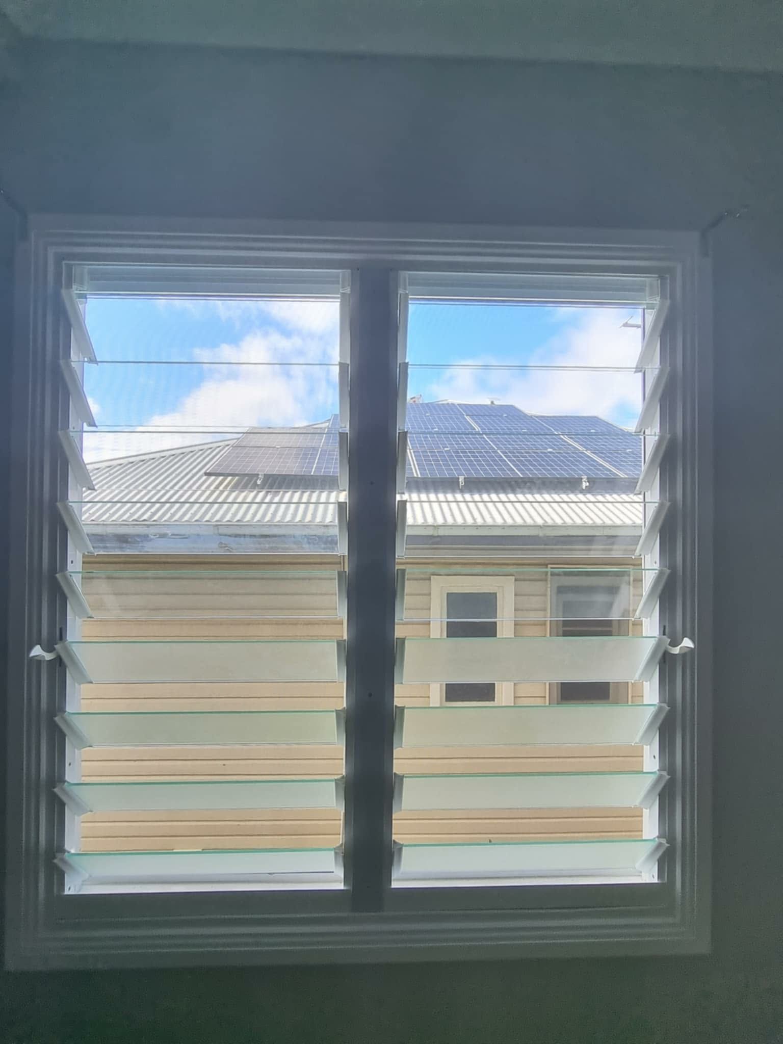 View Through a Window With Horizontal Blinds — Nambucca Glass in Nambucca Heads, NSW