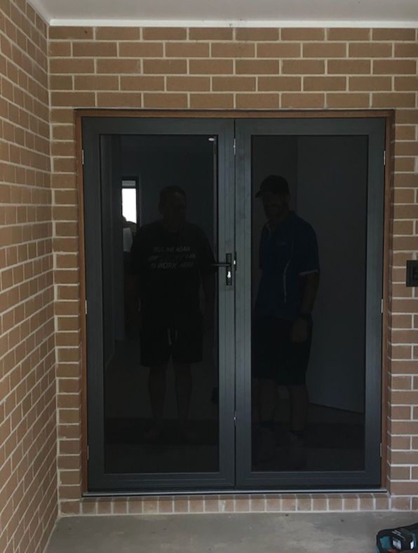 Dark Double Glass Doors Set in a Brick Entryway — Nambucca Glass in Nambucca Heads, NSW