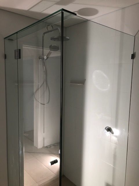 Glass Shower Stall with Clear Doors and Chrome Handles in A Tiled Bathroom — Nambucca Glass in Nambucca Heads, NSW