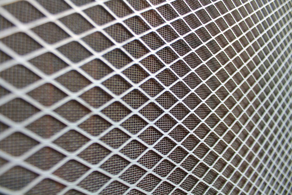 A Close Up Of A Metal Mesh With Holes In It — Nambucca Glass in Nambucca Heads, NSW