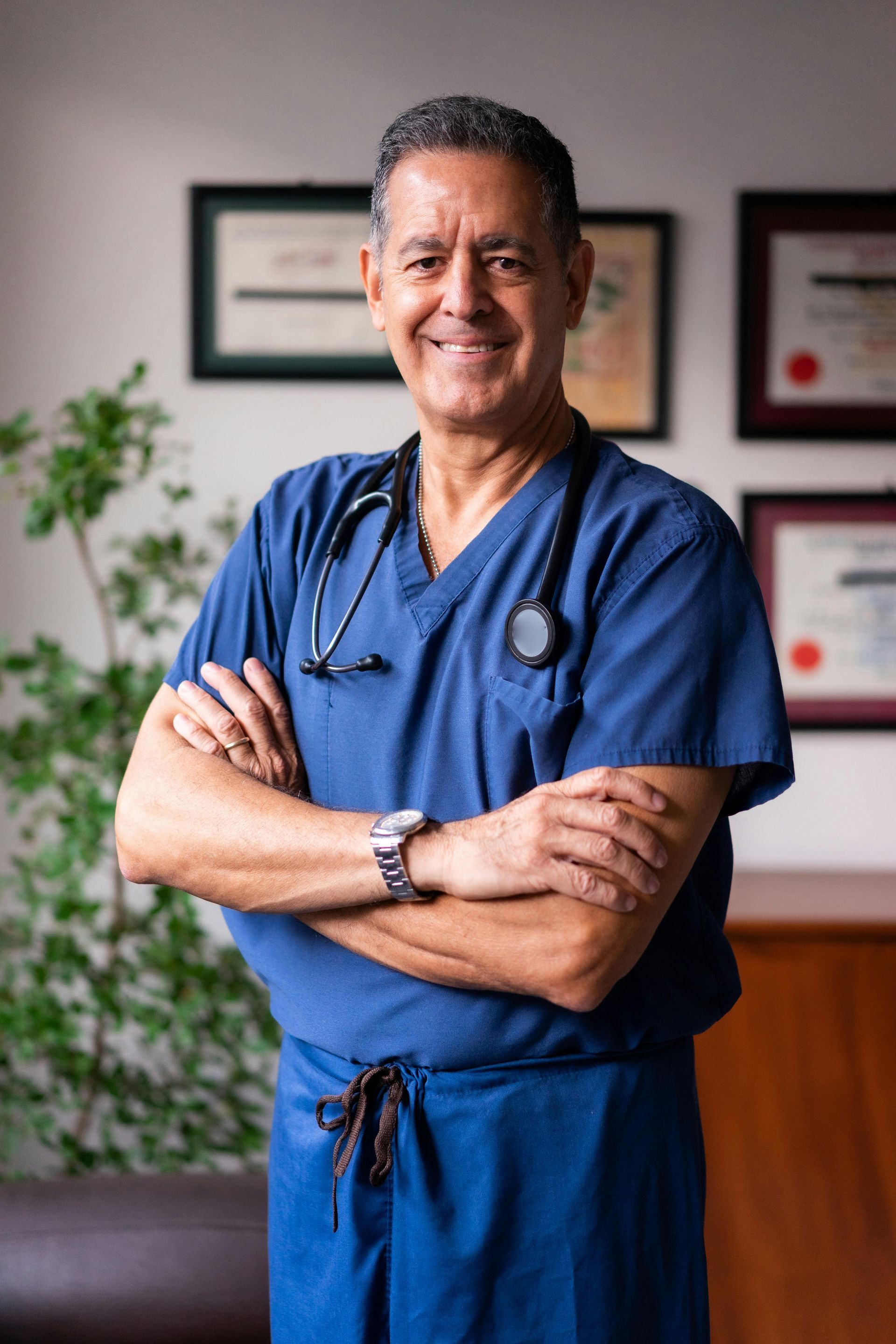 A surgeon wearing a mask and gloves is holding a pair of scissors