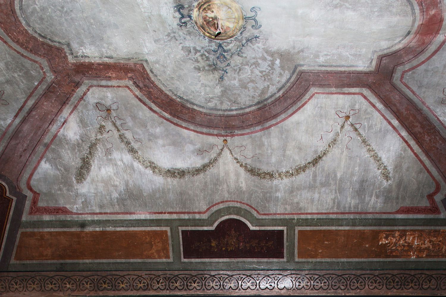 A close up of a ceiling with a painting on it