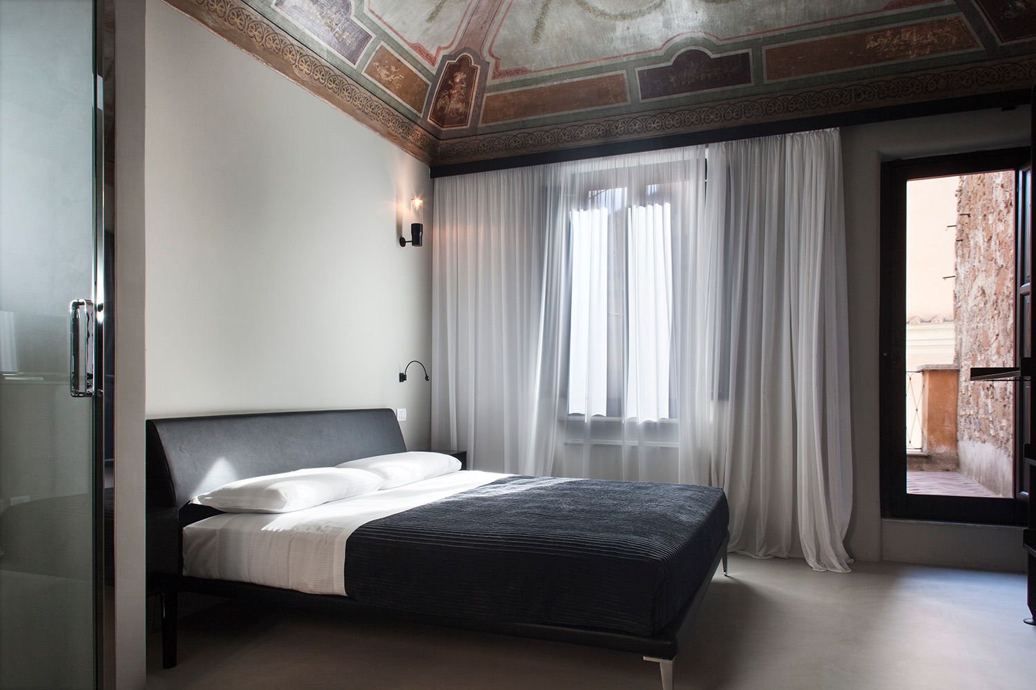 A bedroom with a large bed and a window