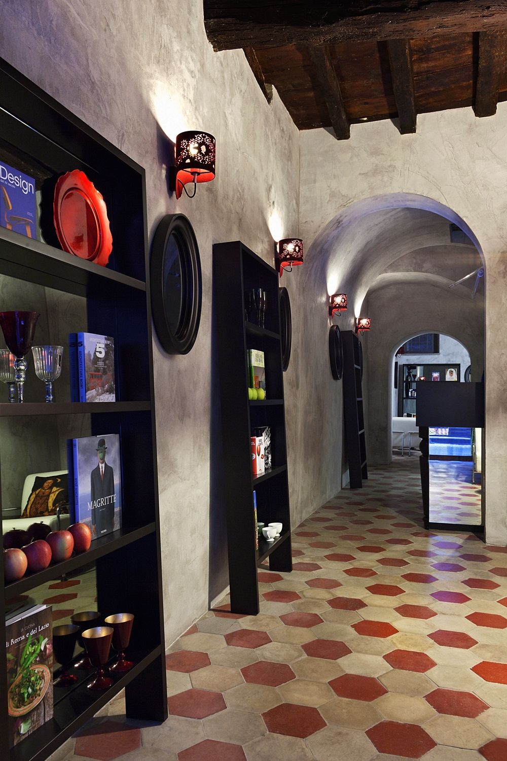 A hallway with bookshelves and a clock on the wall