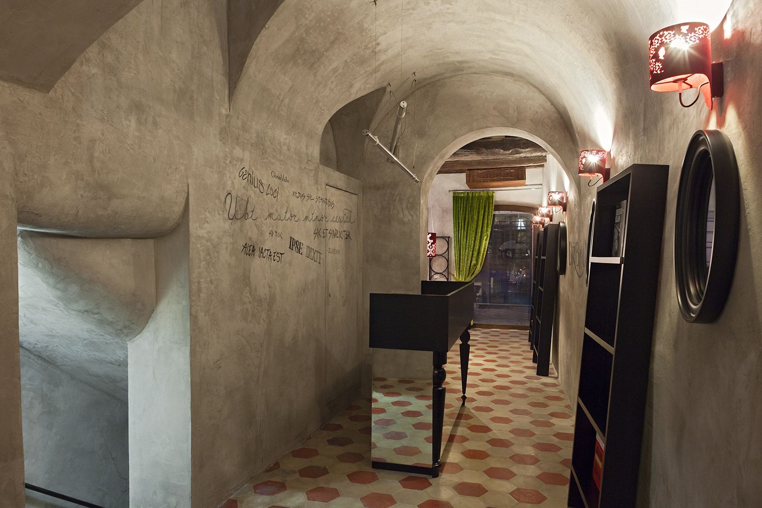 A hallway with a mirror and a clock on the wall