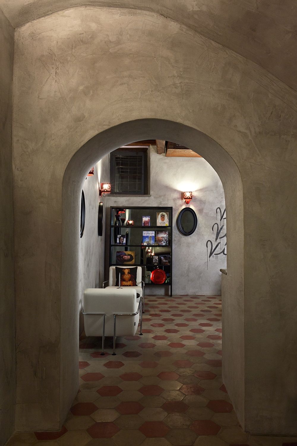 A hallway with an archway leading to a living room
