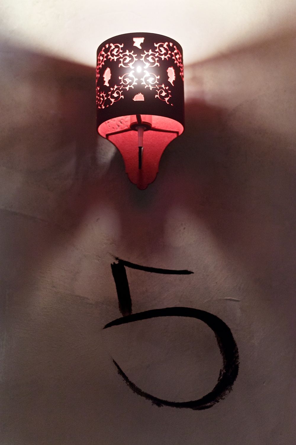 The number 5 is on the wall next to a lamp