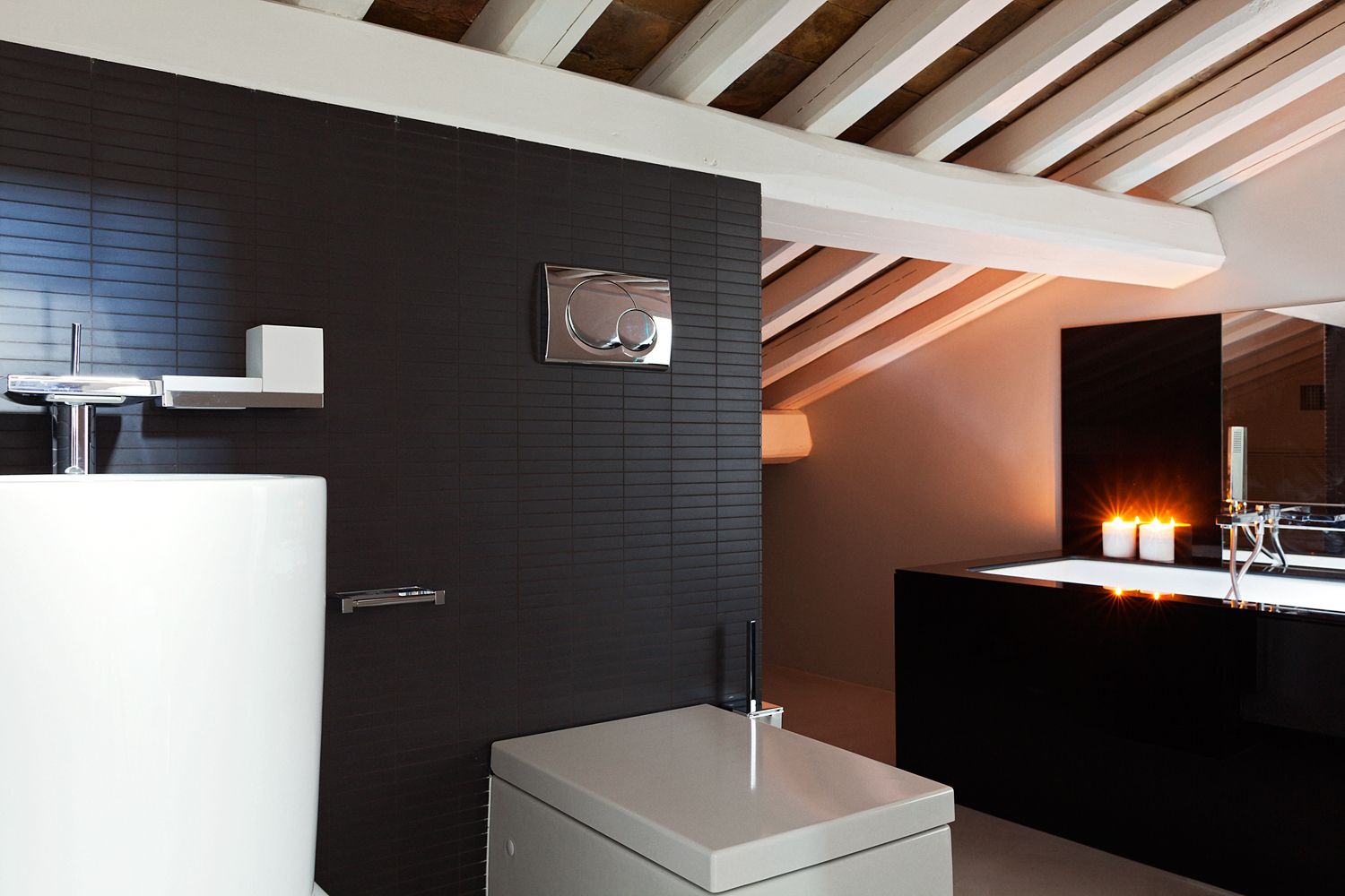 A bathroom with a toilet a sink and a bathtub