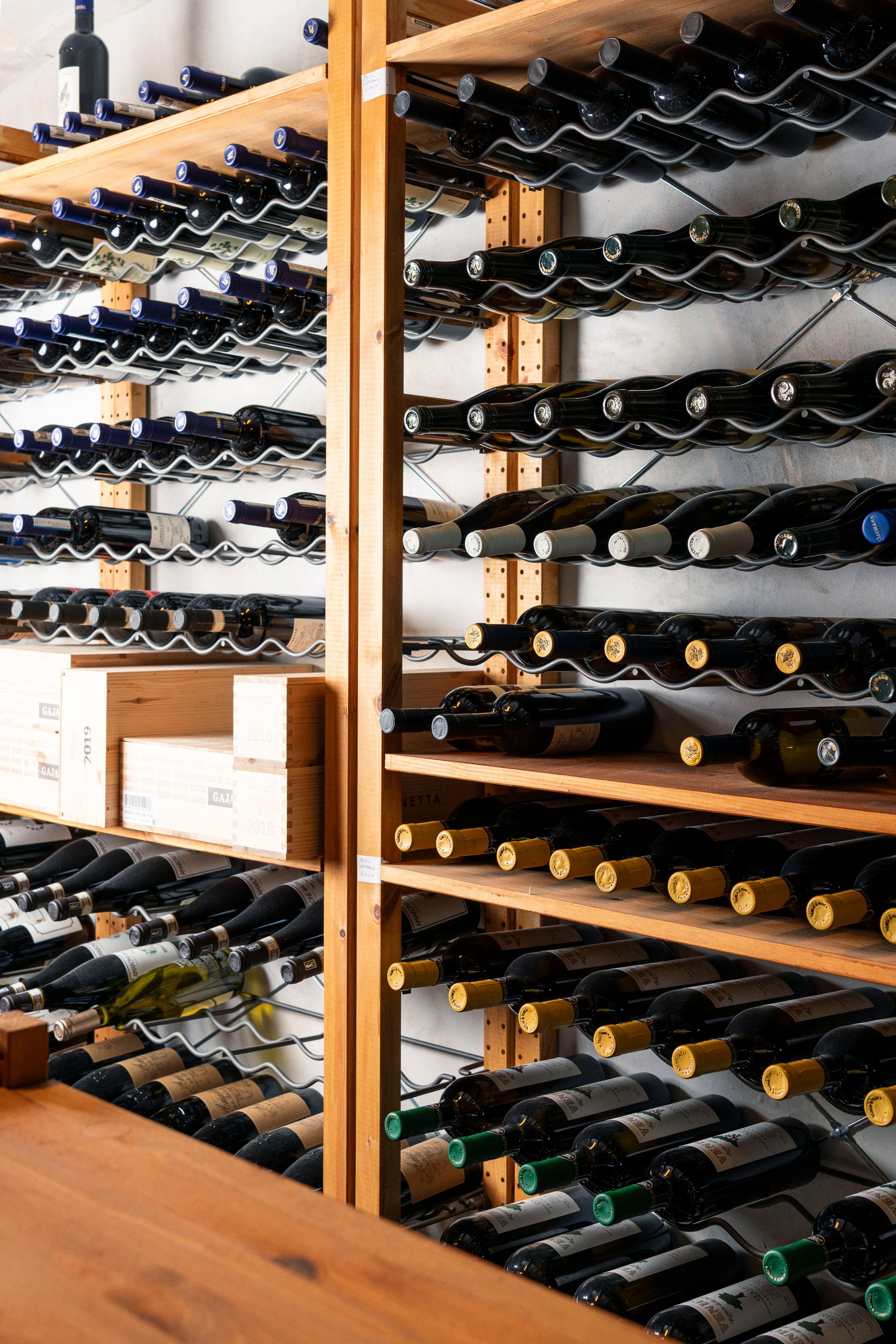 A wine cellar filled with lots of bottles of wine.