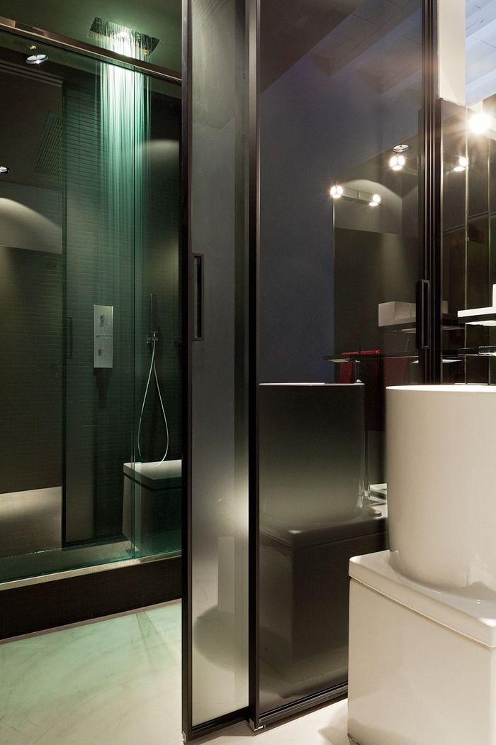 A bathroom with a sliding glass door and a sink