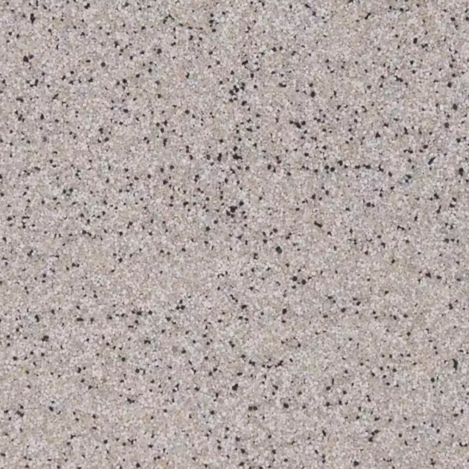 Tan surface with small black speckles.