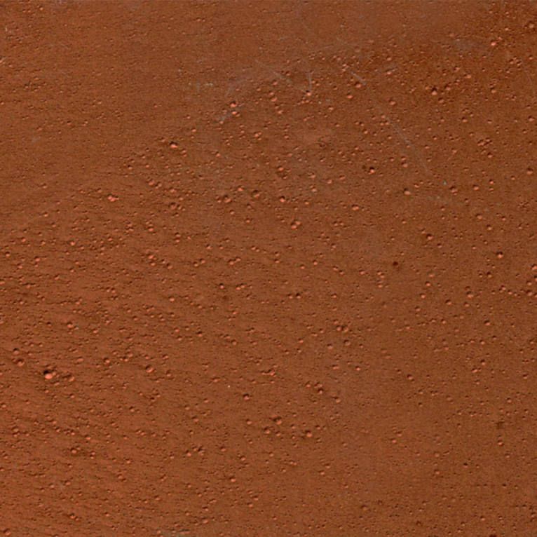Un gros plan d'une surface brune avec de petits trous.