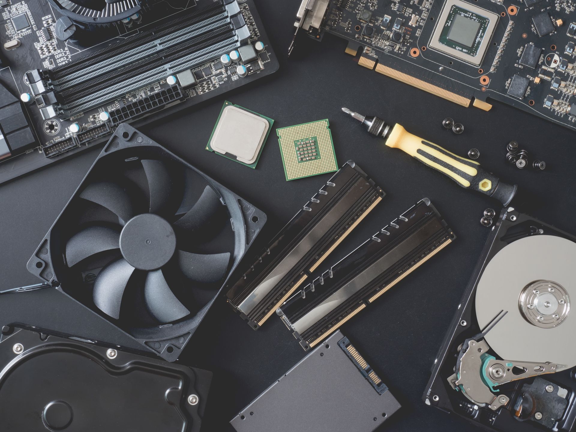 A bunch of computer parts are laying on a table.