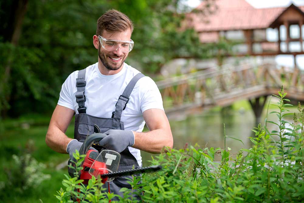 Man Trimming the Shrub — Putnam Valley, NY — B & B Landscaping & Gardening Inc.