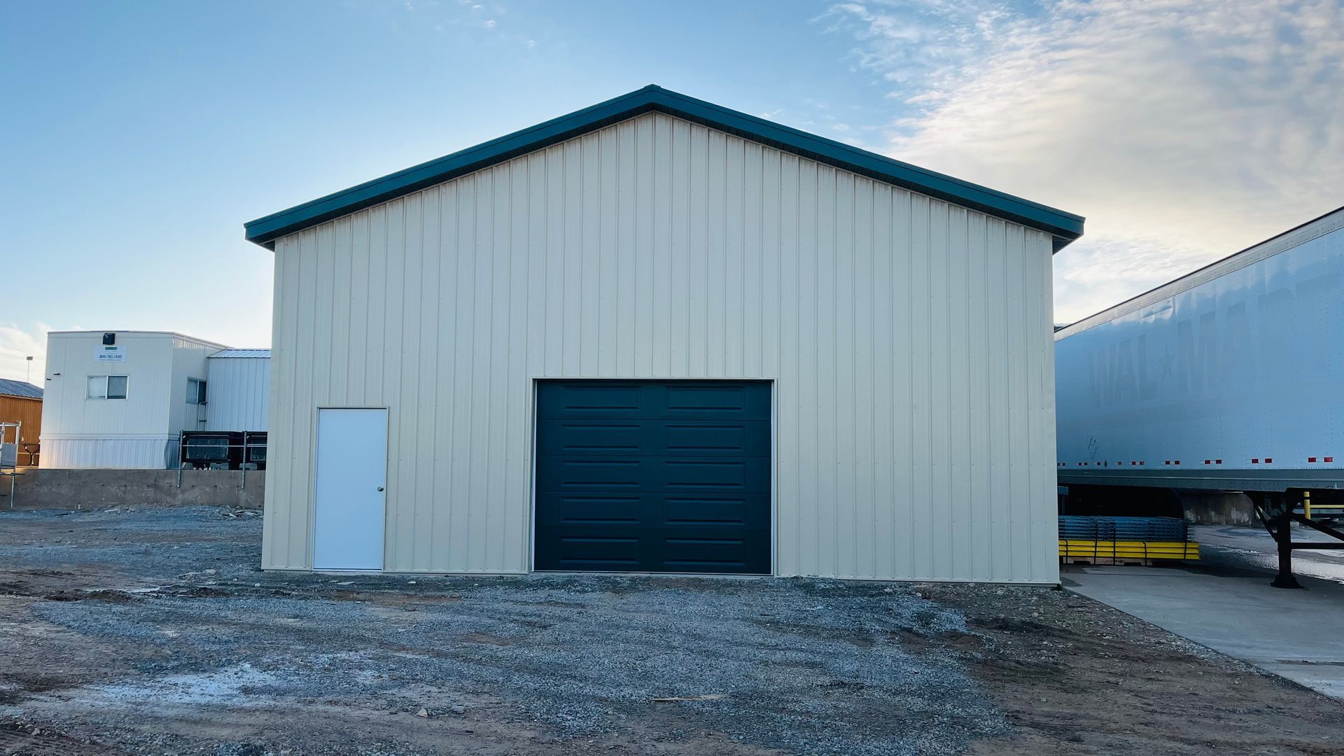Front view of a new commercial steel building with metal siding and garage door in Platteville, WI