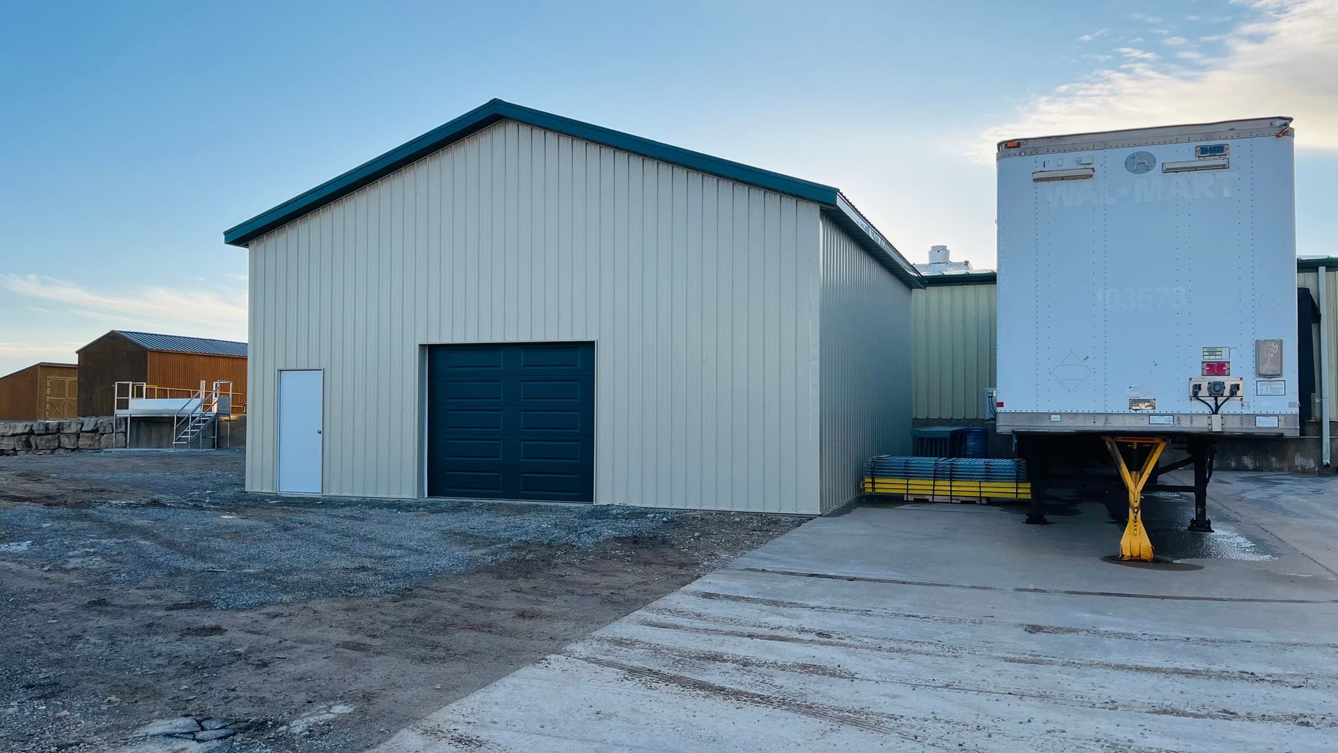 Commercial steel building addition beside a loading area and trailer in Platteville, Wisconsin