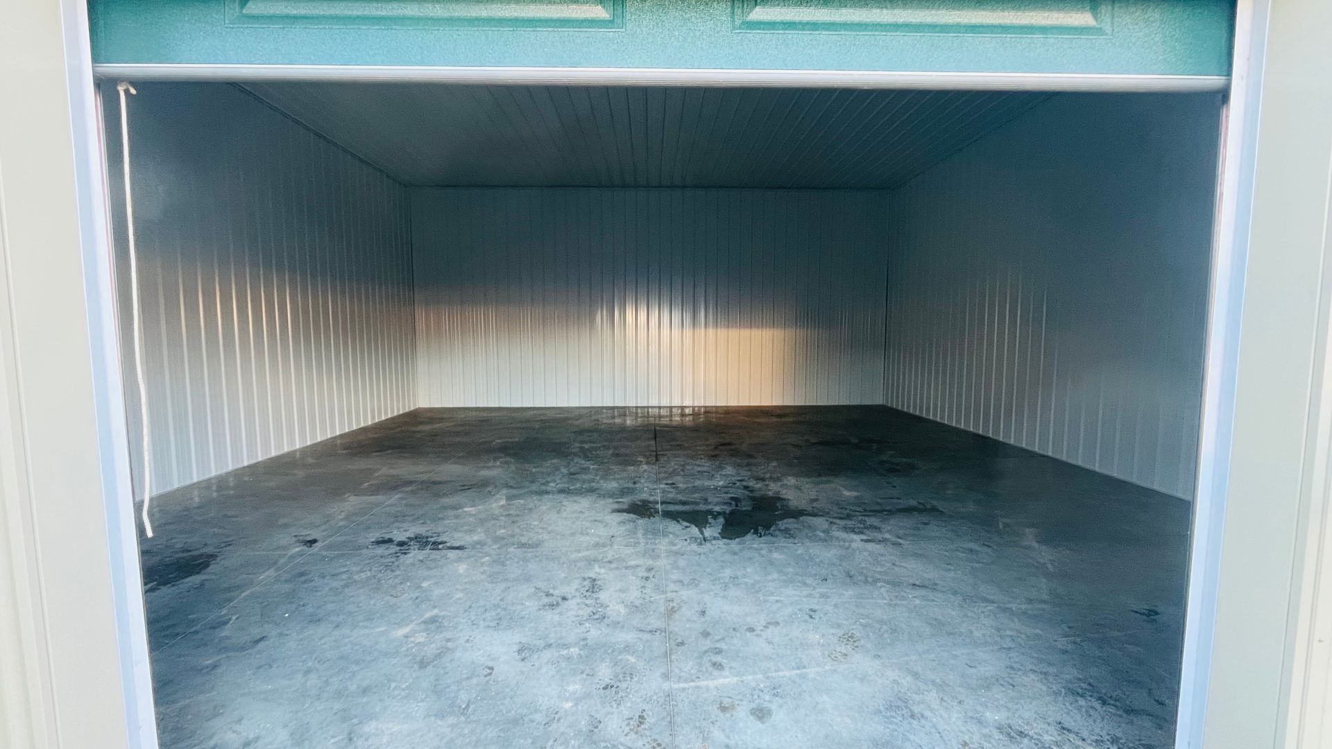 Finished interior of a Platteville steel building with metal walls, ceiling, and concrete floor