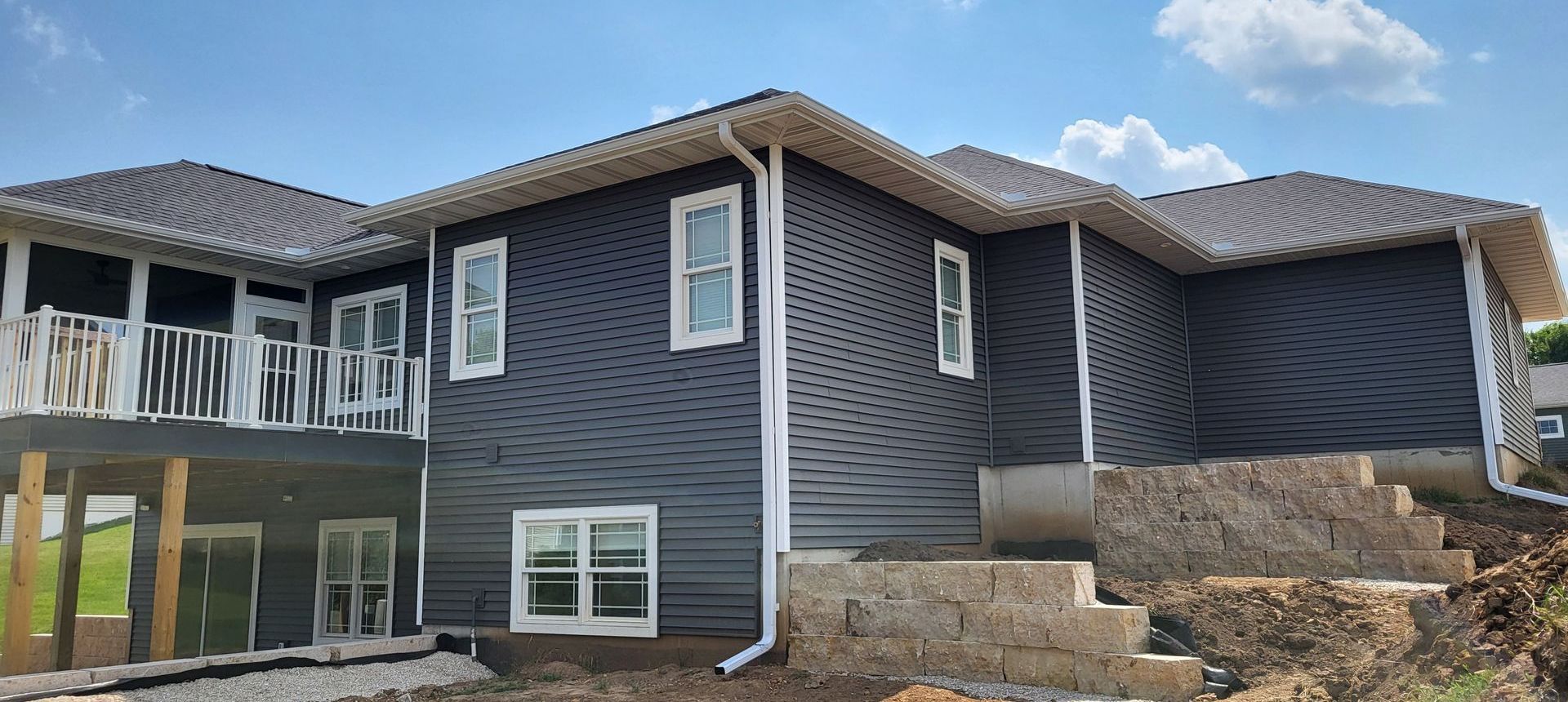 A large house with a lot of windows is being built.