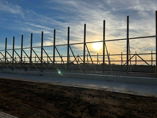 A fence with the sun shining through it