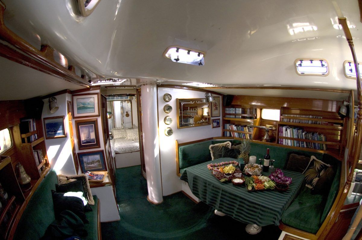 A living room on a boat with a table and chairs