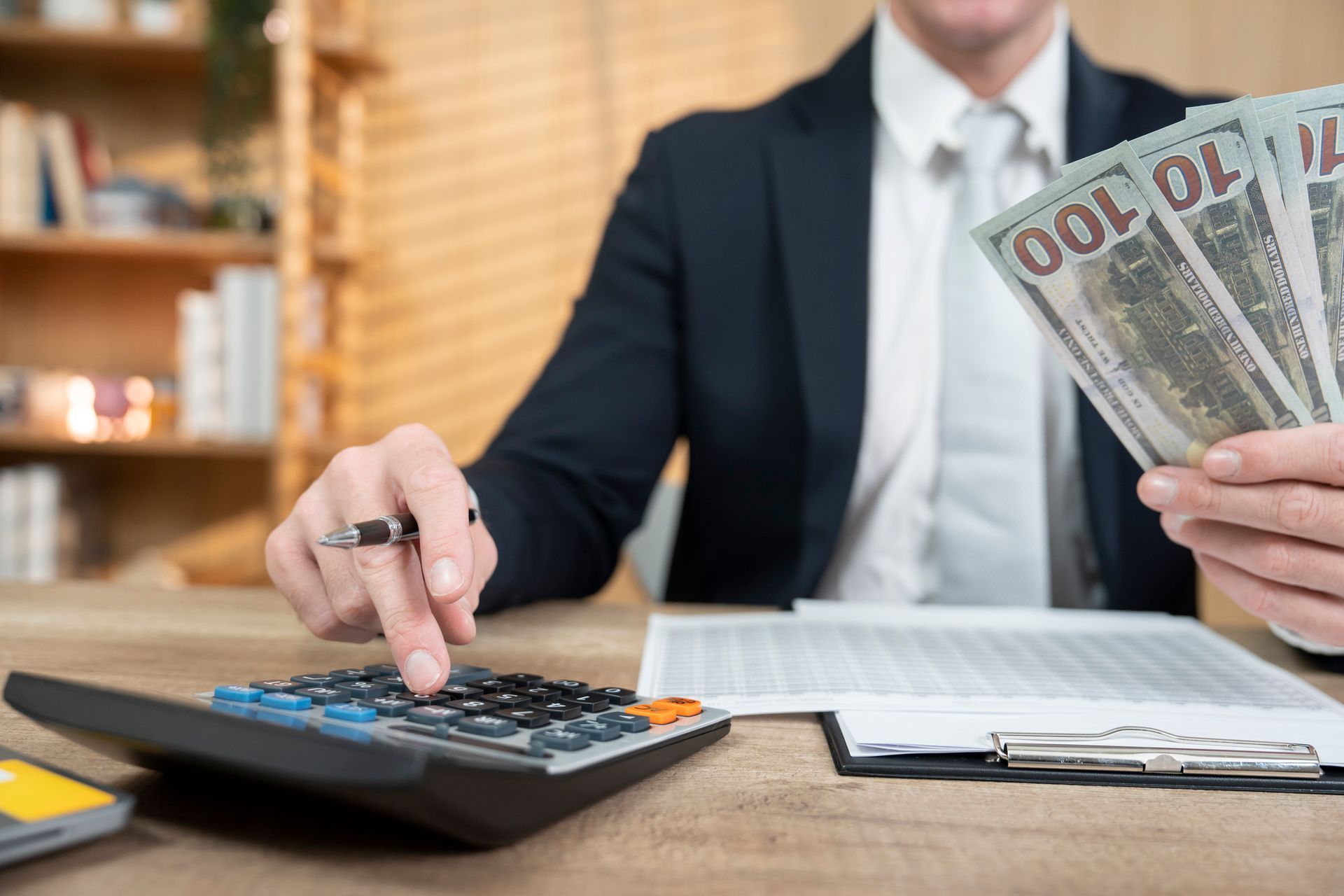 Man calculating loan with collateral, financial planning, and securing loan with assets for approval and credit assessment Man calculating loan with collateral, financial planning, and securing loan with assets for approval and credit assessment