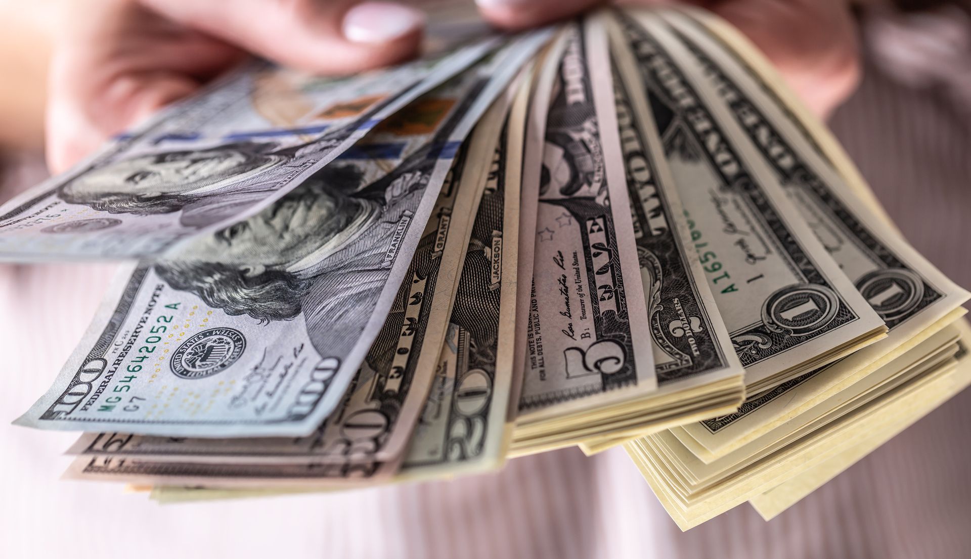 Collateral loan concept with dollars bills in hands, showcasing the exchange of cash for secured loans and financial transactions Collateral loan concept with dollars bills in hands.