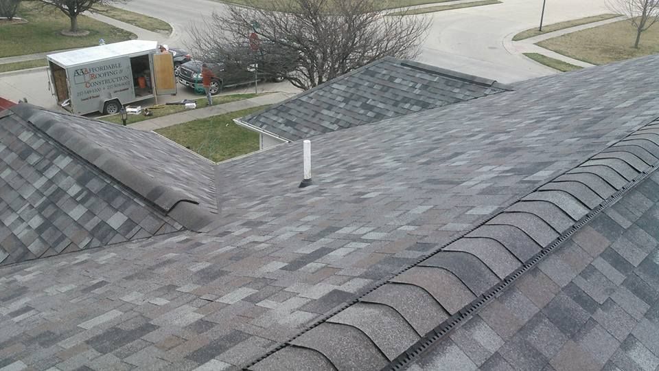 An aerial view of a roof with a white truck parked in the background.