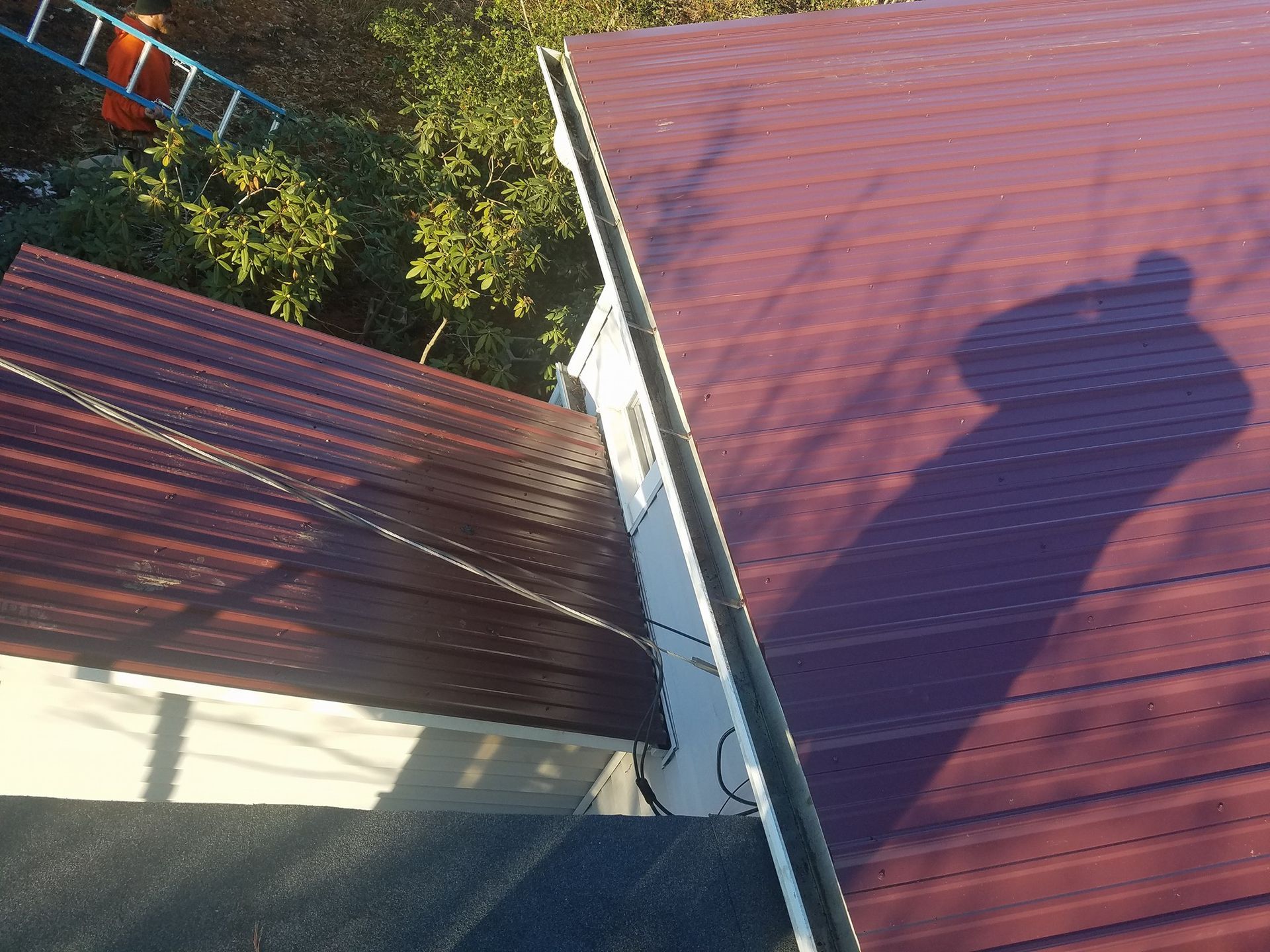 A purple roof with a shadow of a person on it