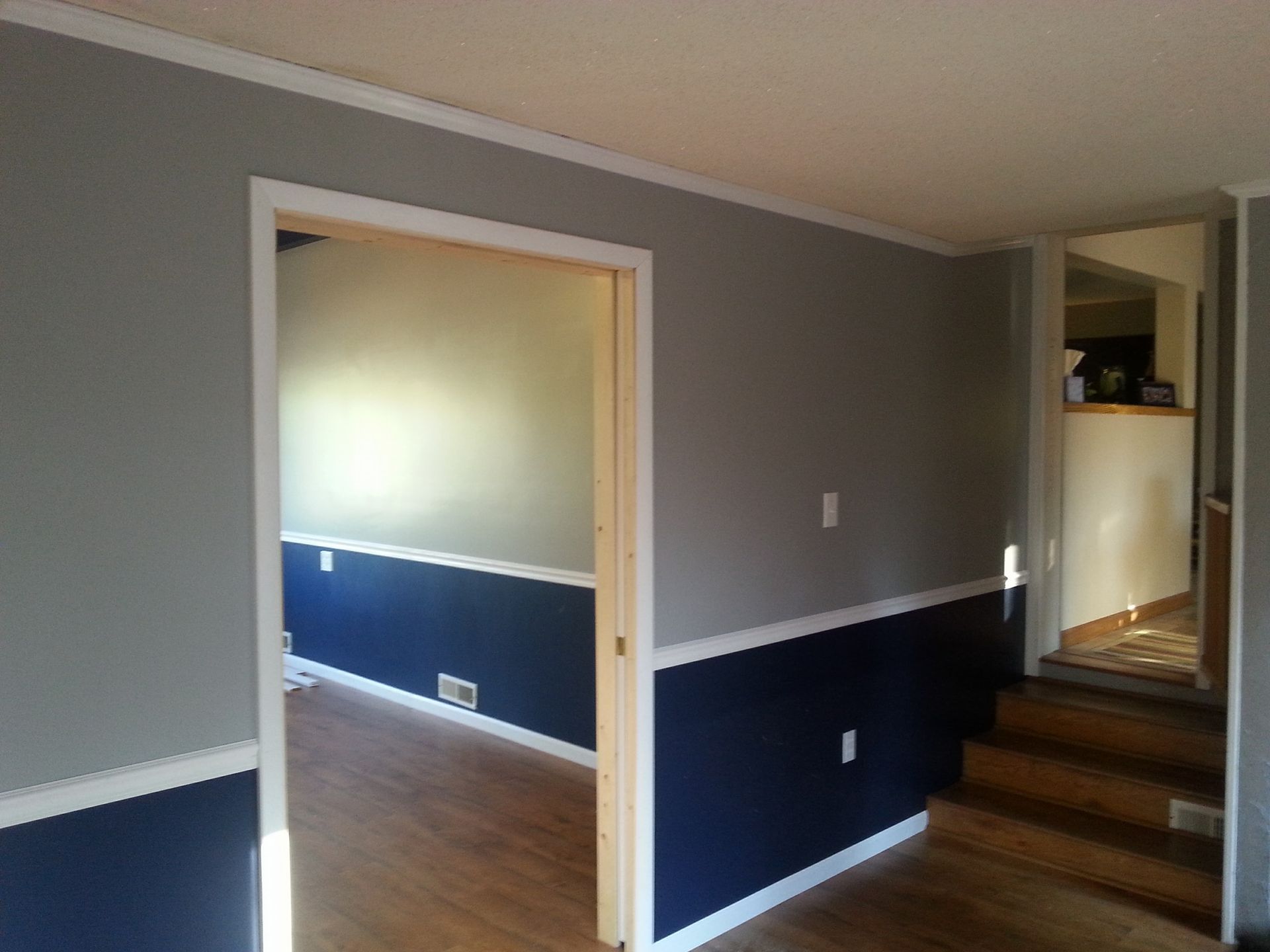 A hallway in a house with blue and gray walls