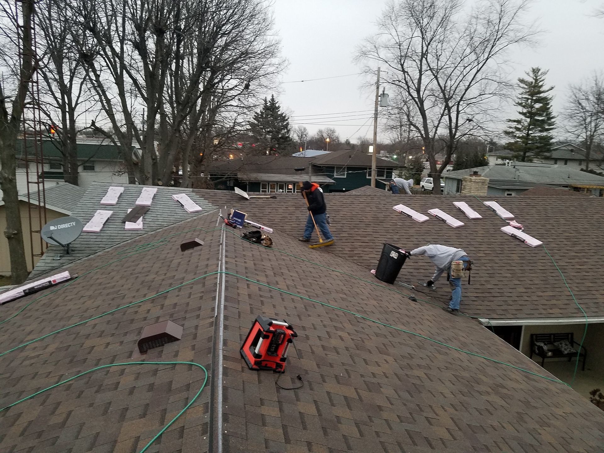 A man is working on the roof of a house.