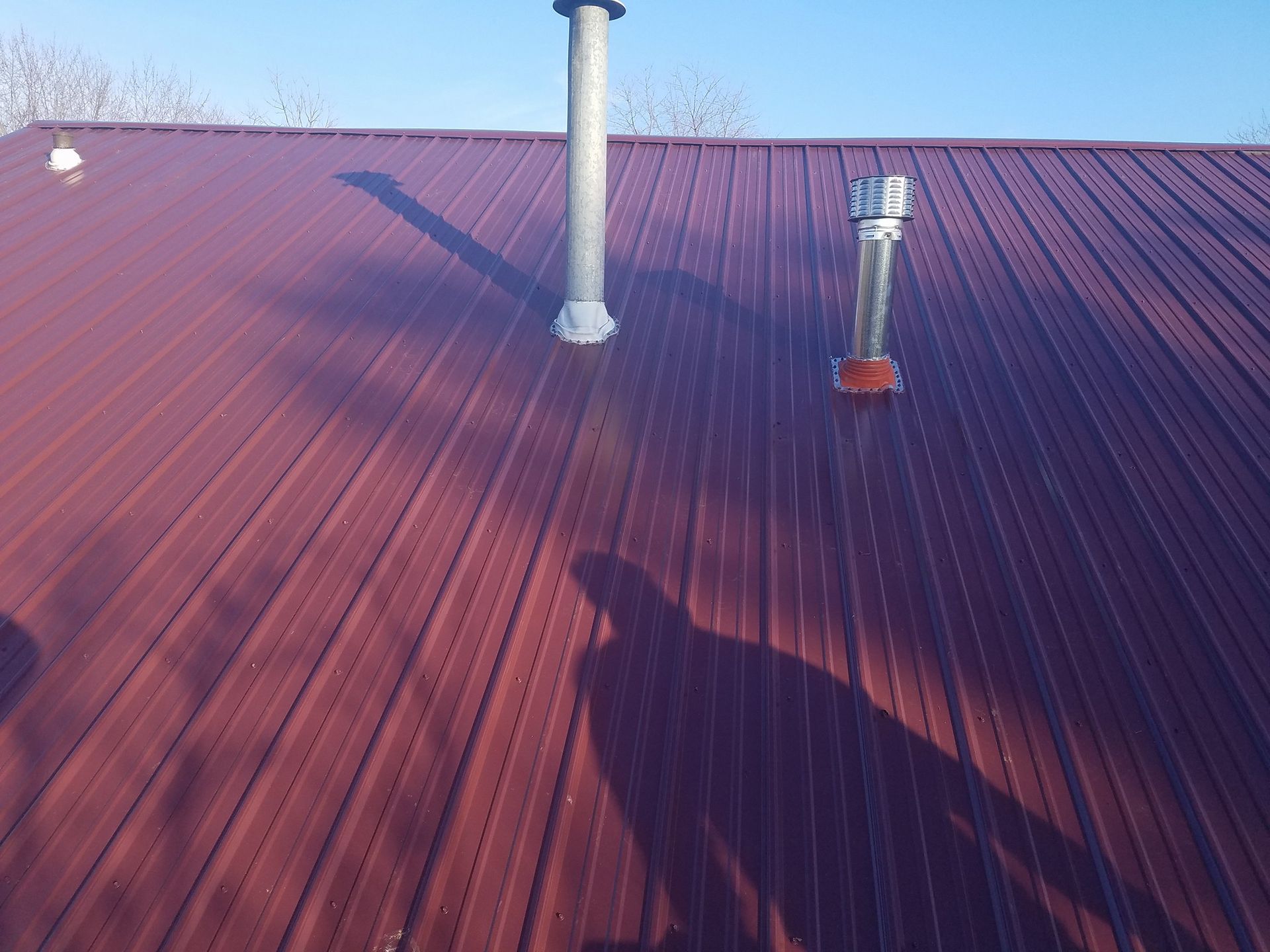 A red roof with a chimney on top of it