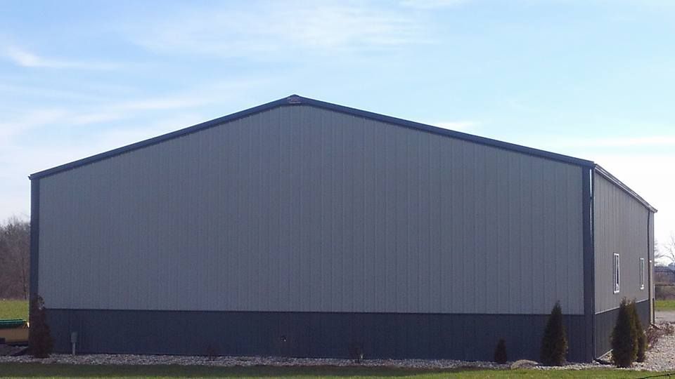 A large gray and black building with a blue sky in the background.