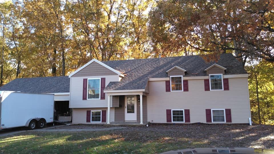 A large house with a trailer parked in front of it