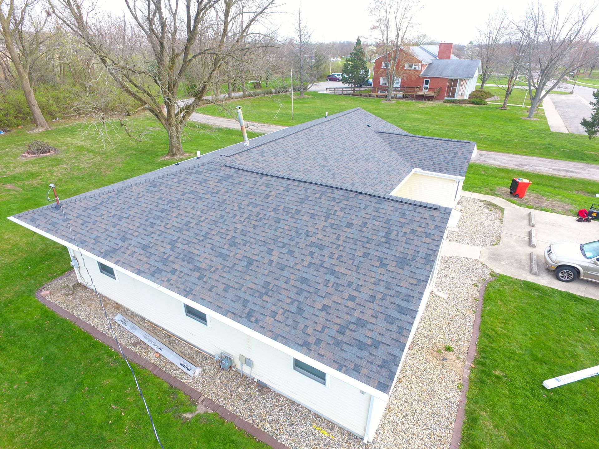 An aerial view of a house with a new roof.