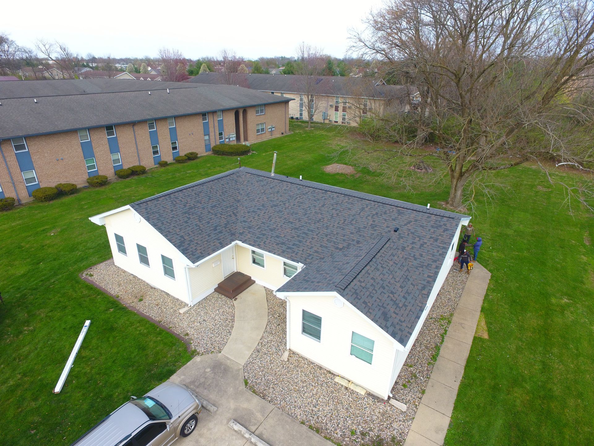 An aerial view of a house with a car parked in front of it.
