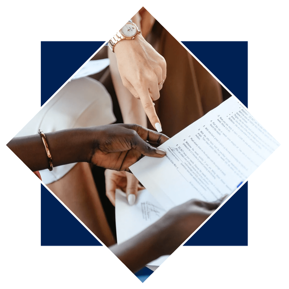 Multiethnic businesswomen checking information in documents