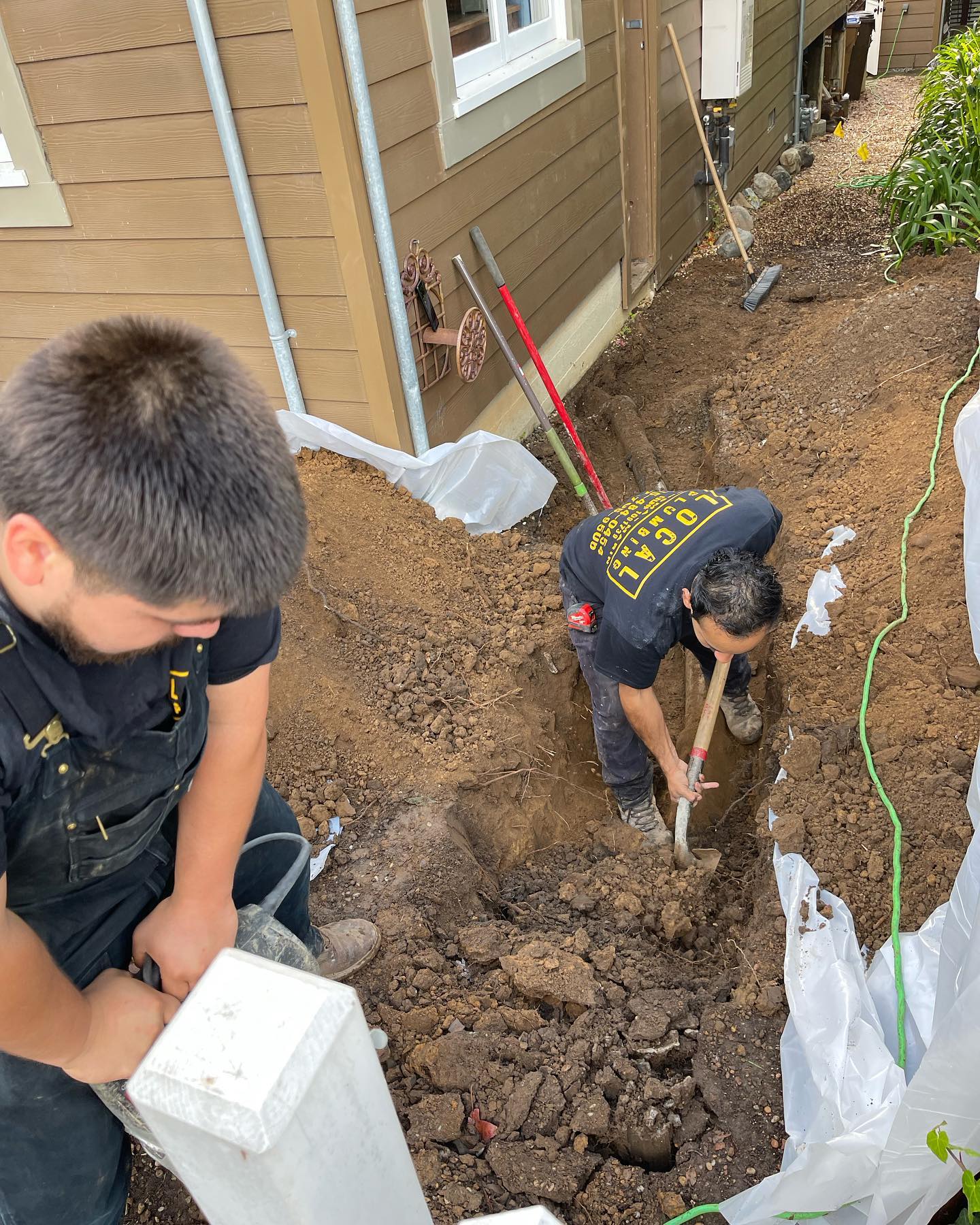 Local Plumbing crew digging a trench to repair a water service line