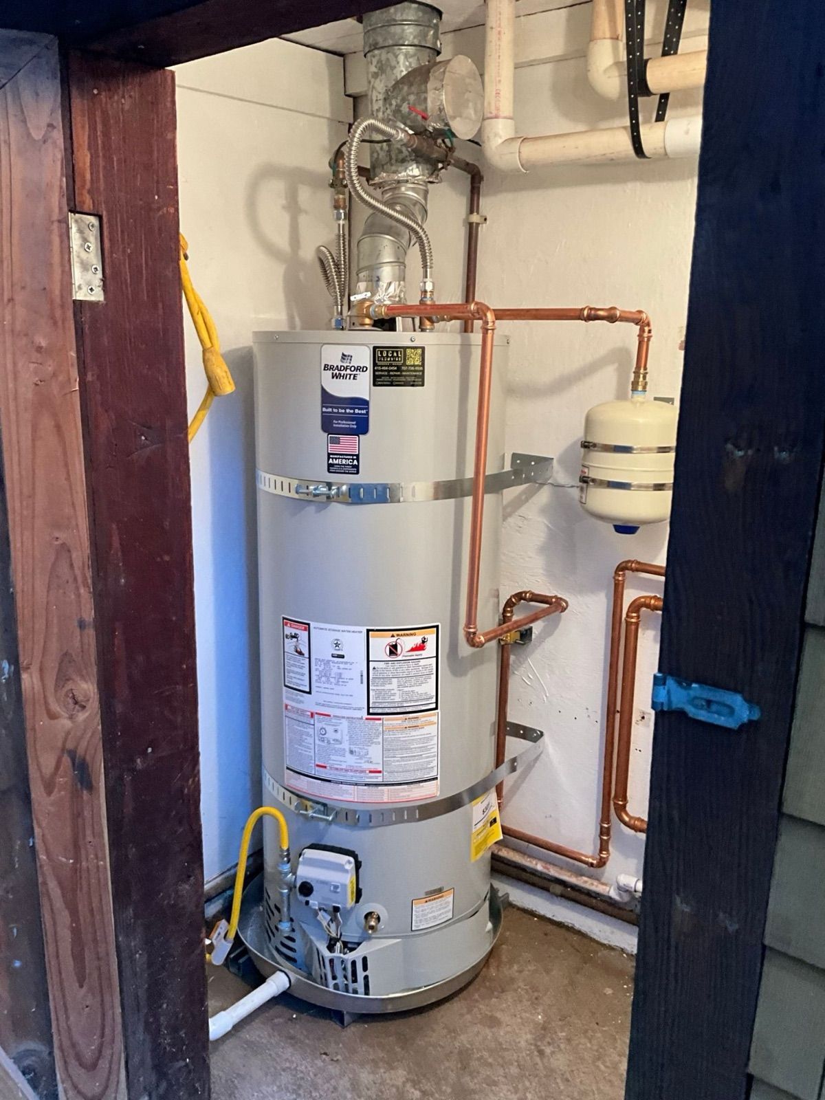 New Bradford White gas water heater installed by Local Plumbing in a utility closet, with seismic straps, expansion tank and new copper piping