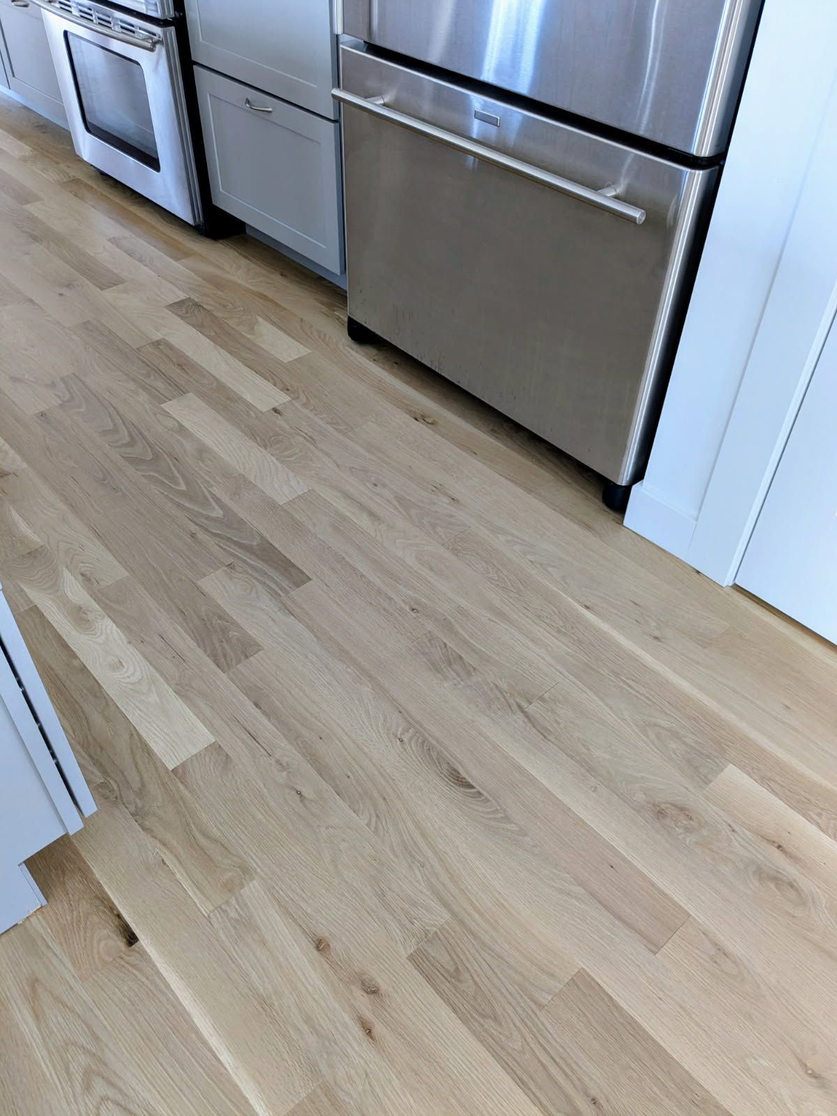 Open doorway with hardwood floors and tile inset.