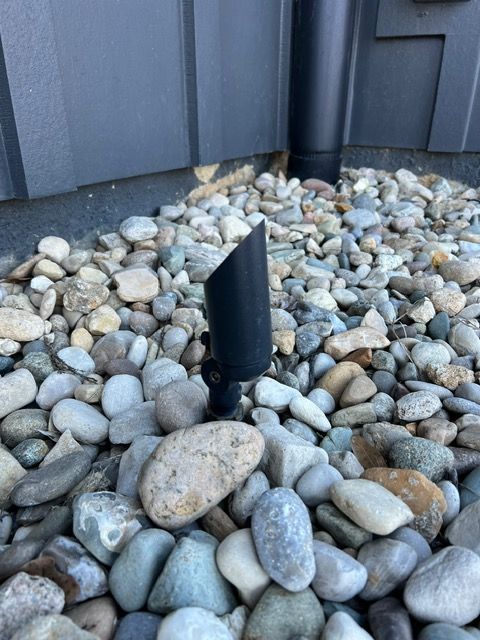 A pile of rocks with a black pipe in the middle