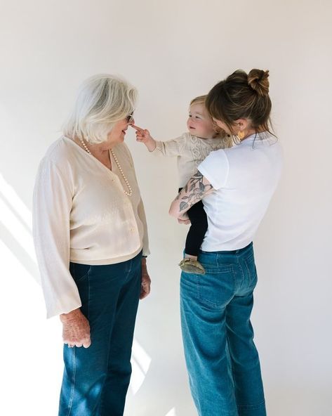 A grandmother with her daughter and grandchild smiling and laughing