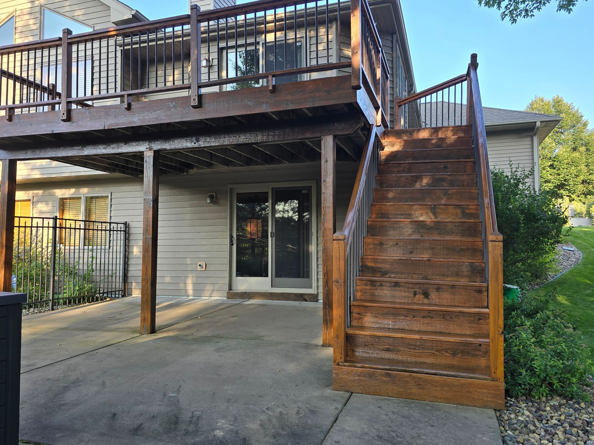 A house with a large deck and stairs leading up to it