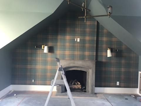 A room with a fireplace and a ladder in it