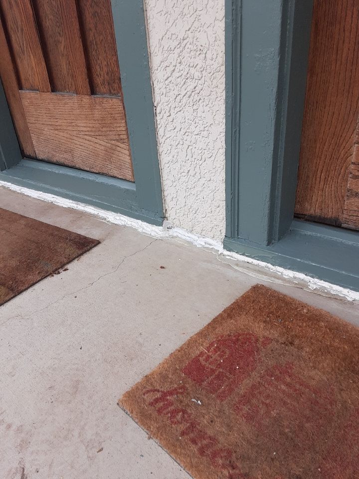 A door with a welcome mat in front of it.