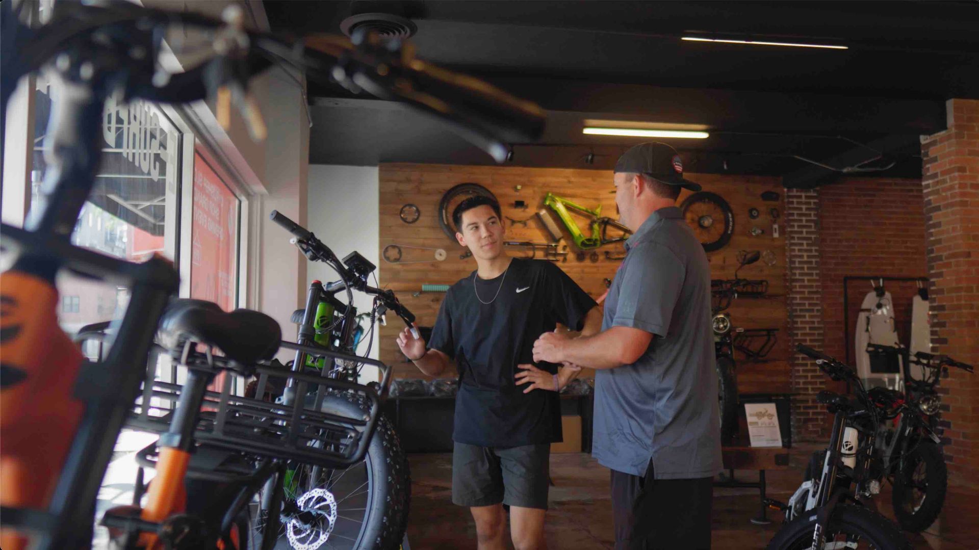 Crowd celebrating the Cyrusher eBike store grand opening with customers and team interviews.