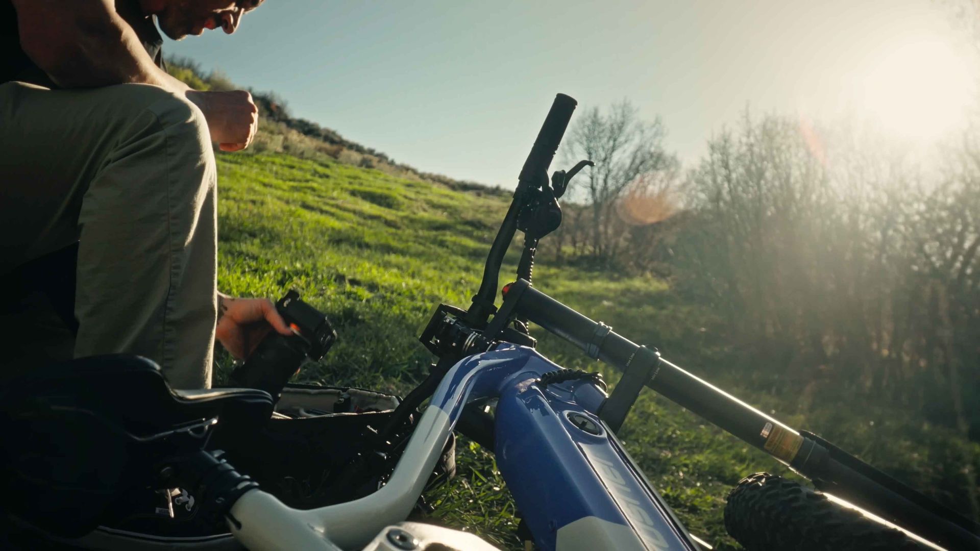 Photographer riding a Cyrusher eBike through scenic mountain light at golden hour.
