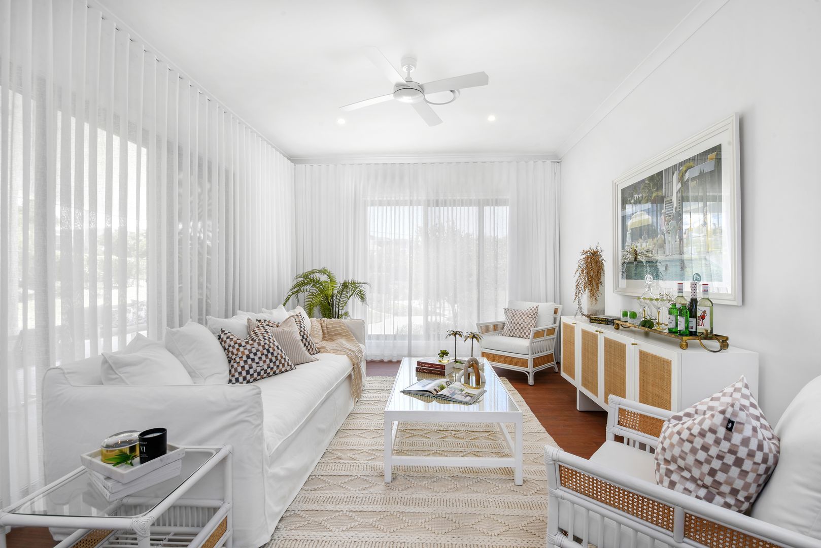 A living room filled with furniture and a ceiling fan.