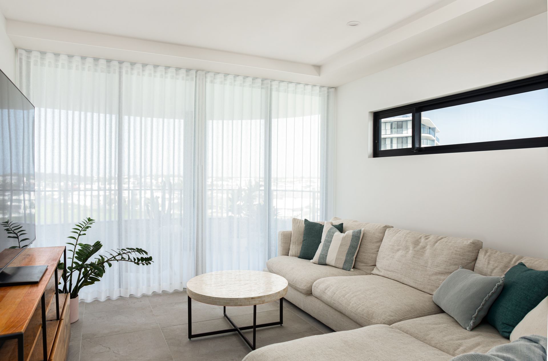 A living room with a couch , table , and television.